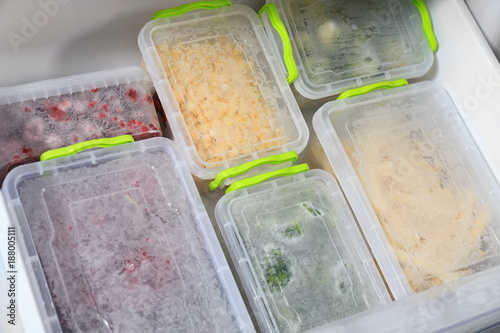 Containers with different food in refrigerator