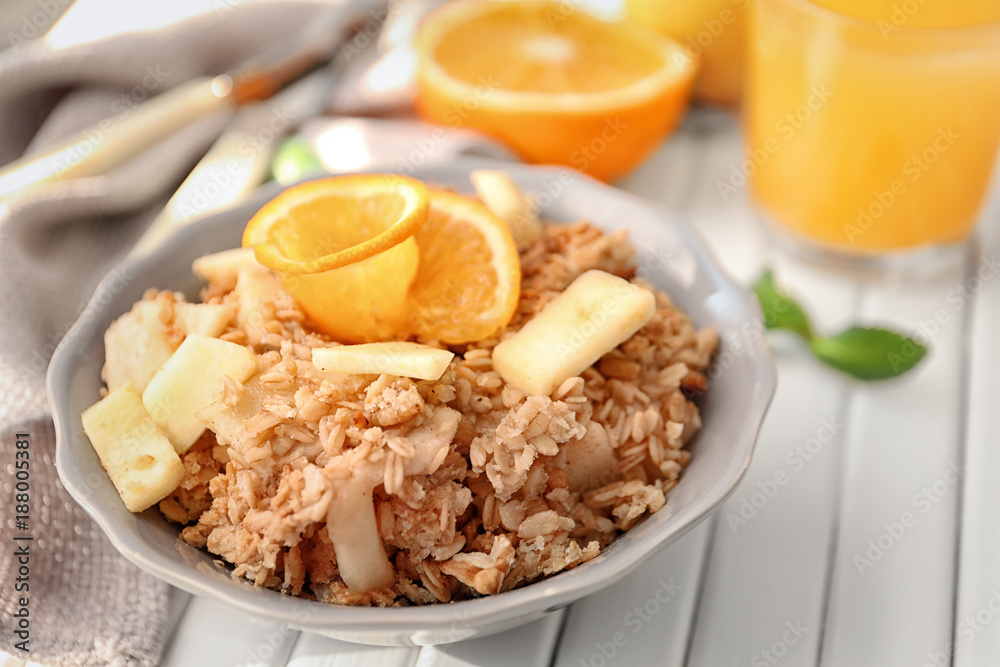 Bowl with apple crisp on table, closeup