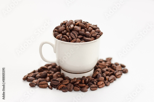 Coffee beans in coffee cup on white background