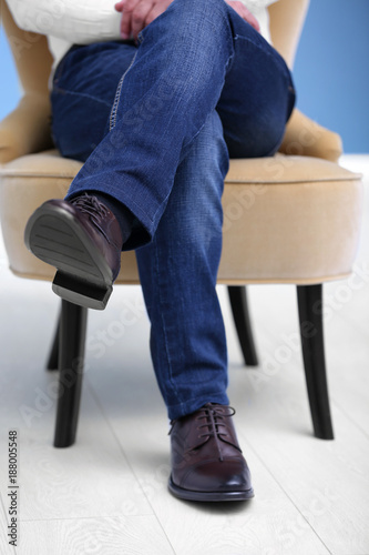Man in elegant leather shoes indoors, closeup