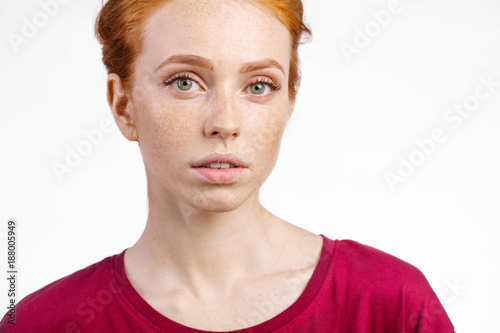 face of beautiful young redhead girl with clean fresh face and neutral emotions close up