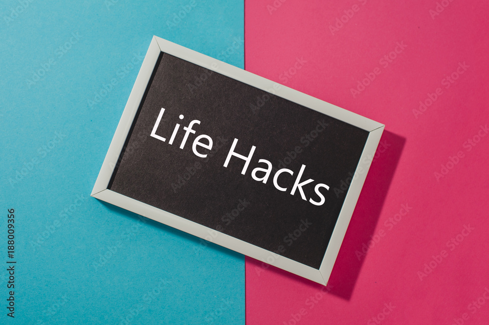 Life hacks - text on chalkboard on blue and pink bright background. Life hacks - text on chalkboard on blue and pink bright background.