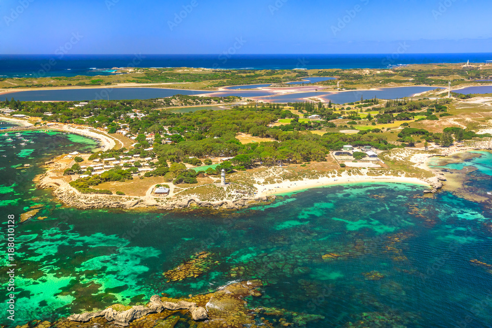 Aerial view of Bathurst Lighthouse and Pinky Beach in Rottnest Island, Australia, on a sunny day. Scenic flight over famous tourist destination of Western Australia. Indian Ocean with reef. Copy space