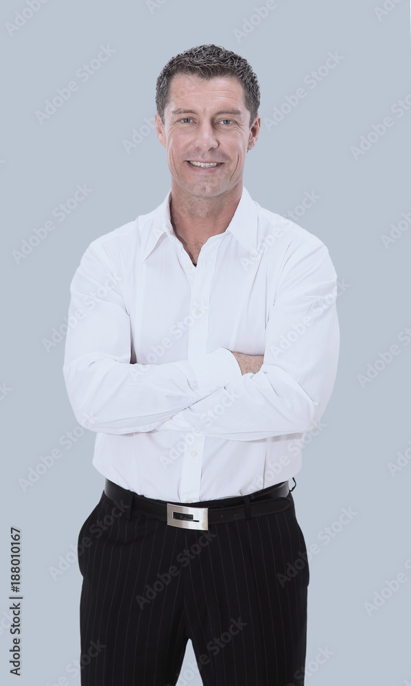 Happy mature man in shirt smiling while standing against gray Happy mature man in shirt smiling while standing against gray