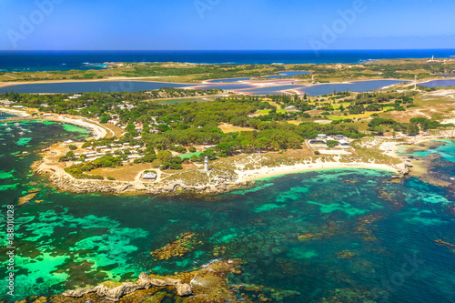 Aerial view of Bathurst Lighthouse and Pinky Beach in Rottnest Island, Australia, on a sunny day. Scenic flight over famous tourist destination of Western Australia. Indian Ocean with reef. Copy space
