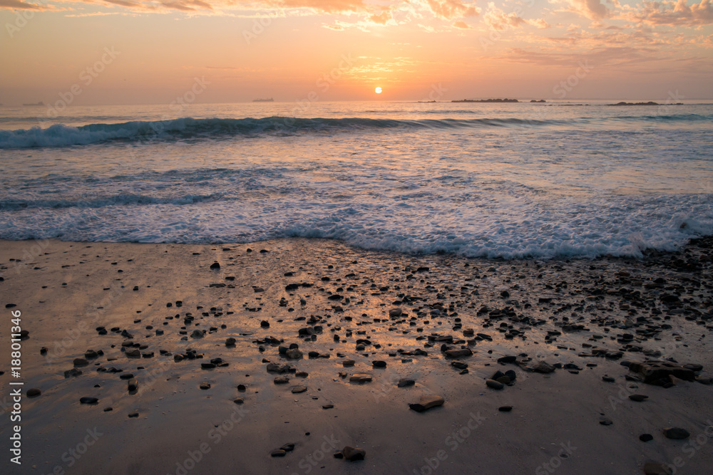 Sunset on rocky beach