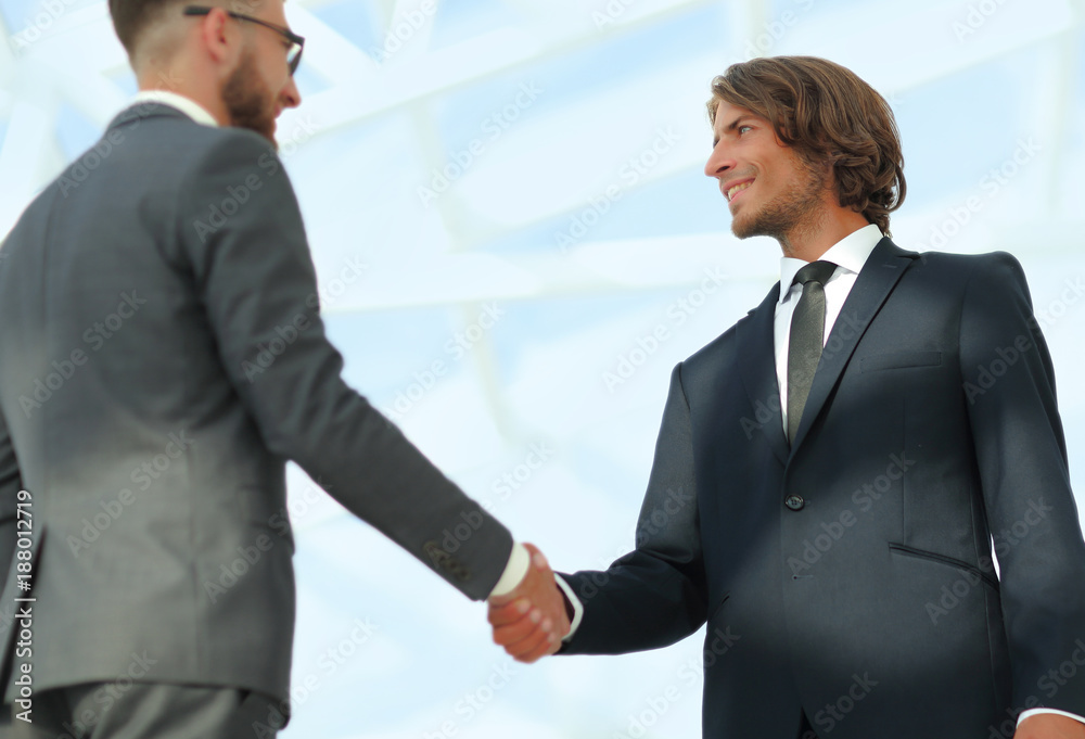 Business handshake and business people. Business handshake and business people.