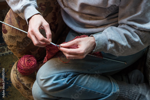 Woman knitting on an armchair