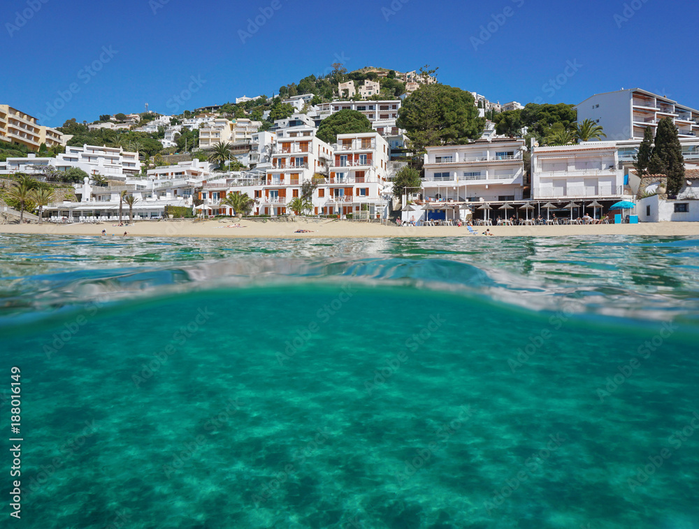 Above and below sea surface, Mediterranean beach with buildings and sand underwater, Spain, Costa Brava, playa Almadrava, Canyelles Grosses, Roses, Girona, Catalonia