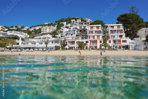 Mediterranean beach shore with buildings in Spain Costa Brava, seen from sea surface, playa Almadrava, Canyelles Grosses, Roses, Girona, Catalonia © dam