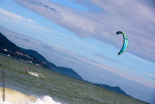 Kite surfer ride waves in summer day