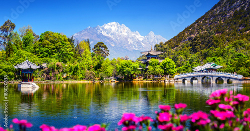 Black Dragon Pool and Jade Dragon Snow Mountain. It's a famous pond in the scenic Jade Spring Park (Yu Quan Park) located at the foot of Elephant Hill, old Town of Lijiang in Yunnan, China. photo