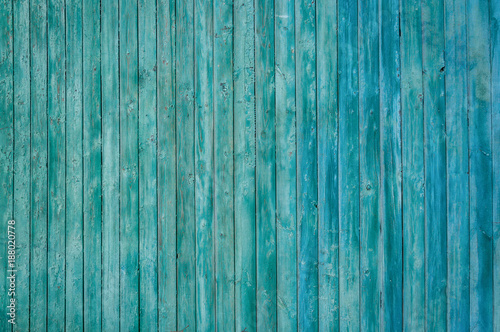 Texture wooden wall with peeling green paint.
