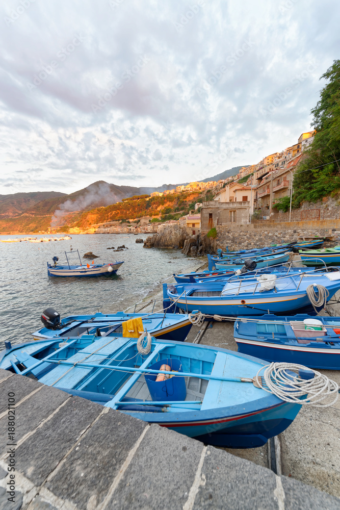 Scilla, Calabria. Docked boats in the city port at summer sunset, Italy
