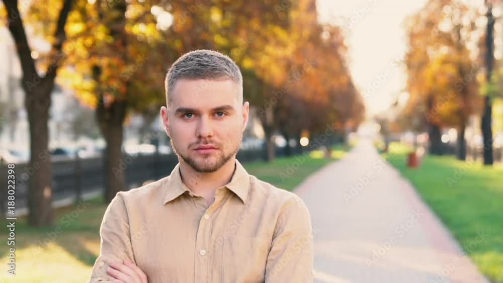 Slow Motion Portrait of serious caucasian man smiling in city Slow Motion Portrait of serious caucasian man smiling in city