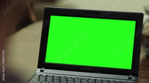 Wallpaper Mural Netbook Computer with Green Screen. Close Up. Zoom In.  You can replace green screen with the footage or picture you want with “Keying” effect in After Effects  (check out tutorials on YouTube).  Torontodigital.ca