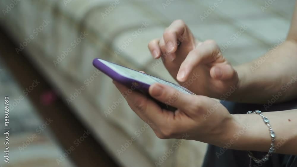 young woman writing sms sitting on sofa at home young woman writing sms sitting on sofa at home