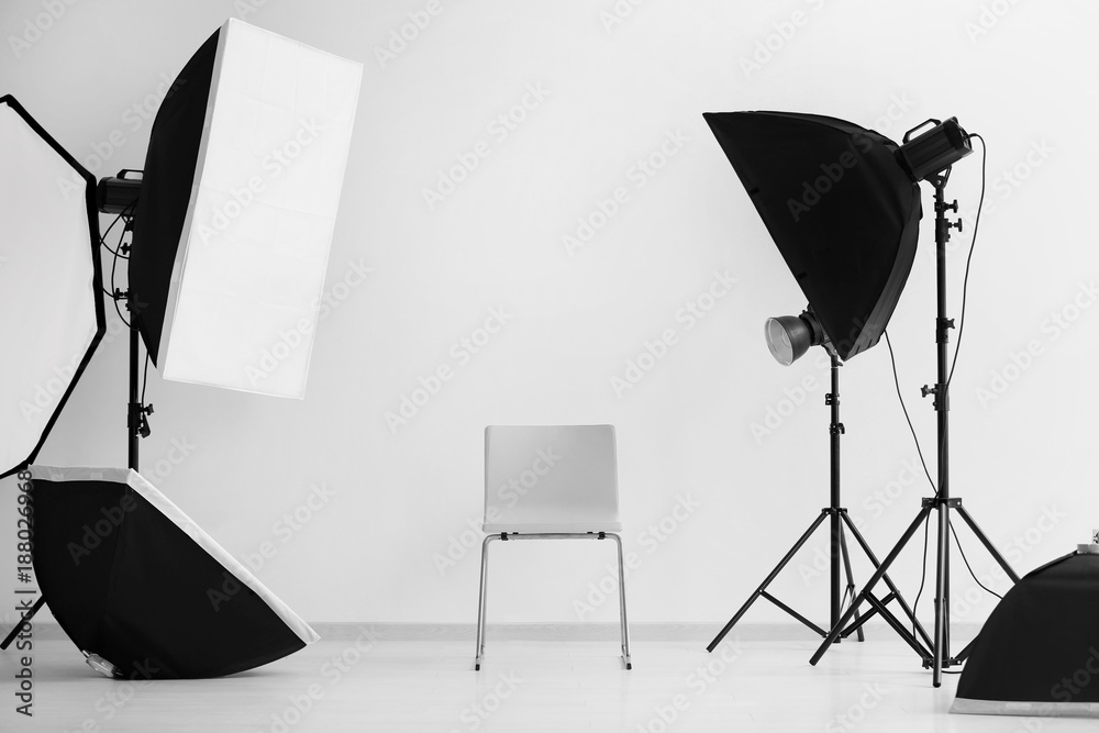 Interior of modern photo studio with chair and professional equipment - obrazy, fototapety, plakaty 