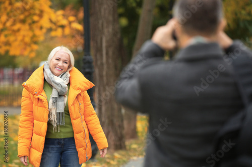 Man taking photo of mature ...