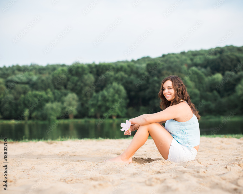 Beautiful brunette teen woman outside on a summer day