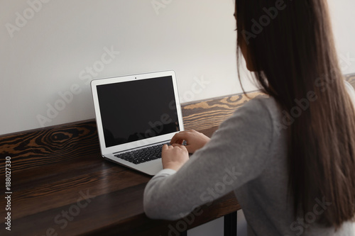 Woman working on laptop in cafe