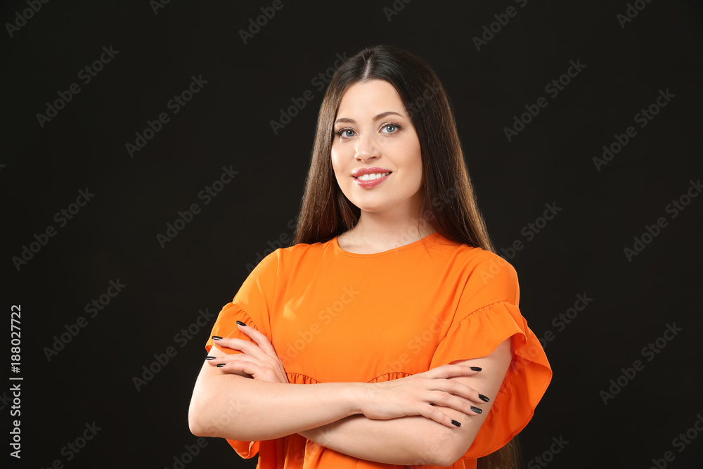 Obraz premium Portrait of beautiful smiling woman on black background