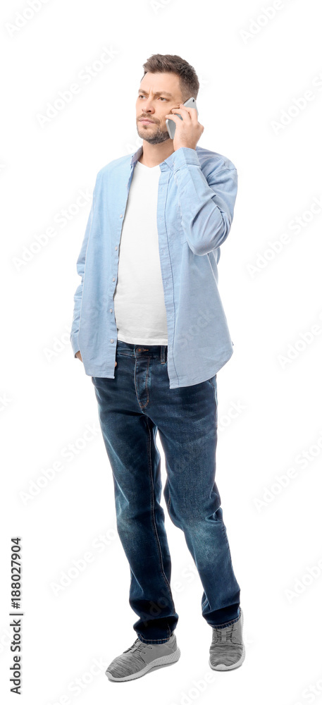 Attractive young man talking on mobile phone on white background Attractive young man talking on mobile phone on white background