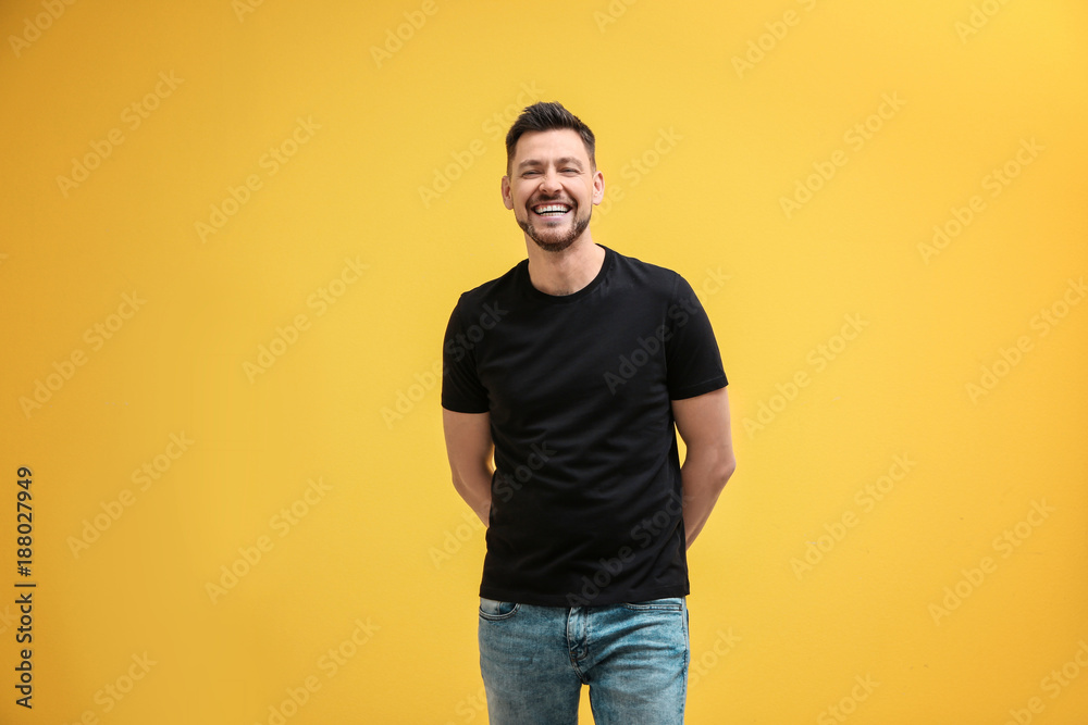 © Africa Studio - Young man in black t-shirt on color background. Mockup for design