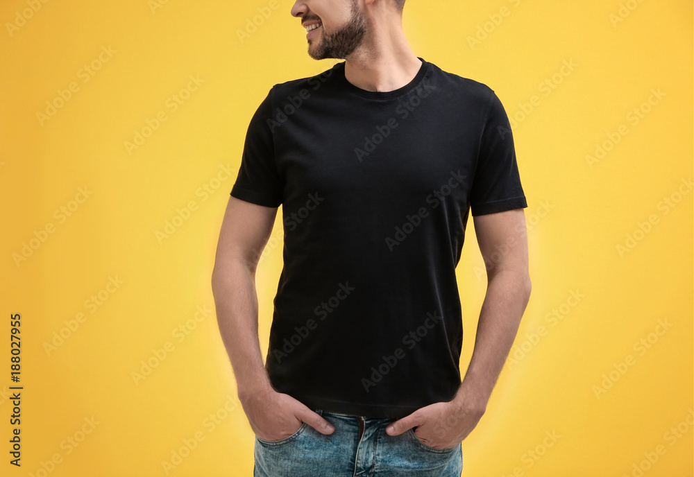 © Africa Studio - Young man in black t-shirt on color background. Mockup for design