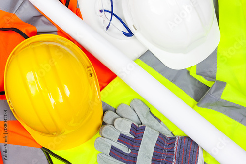 Fényképezés Hard safety hats and protective gloves laying on hi vis vests