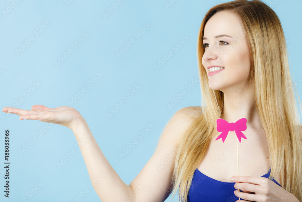 Woman holding carnival accessoies on stick