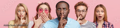 Bild auf Leinwand Horizontal shot of five different people show hush sign, look with stupefied expression, demand complete silence, isolated over pink background