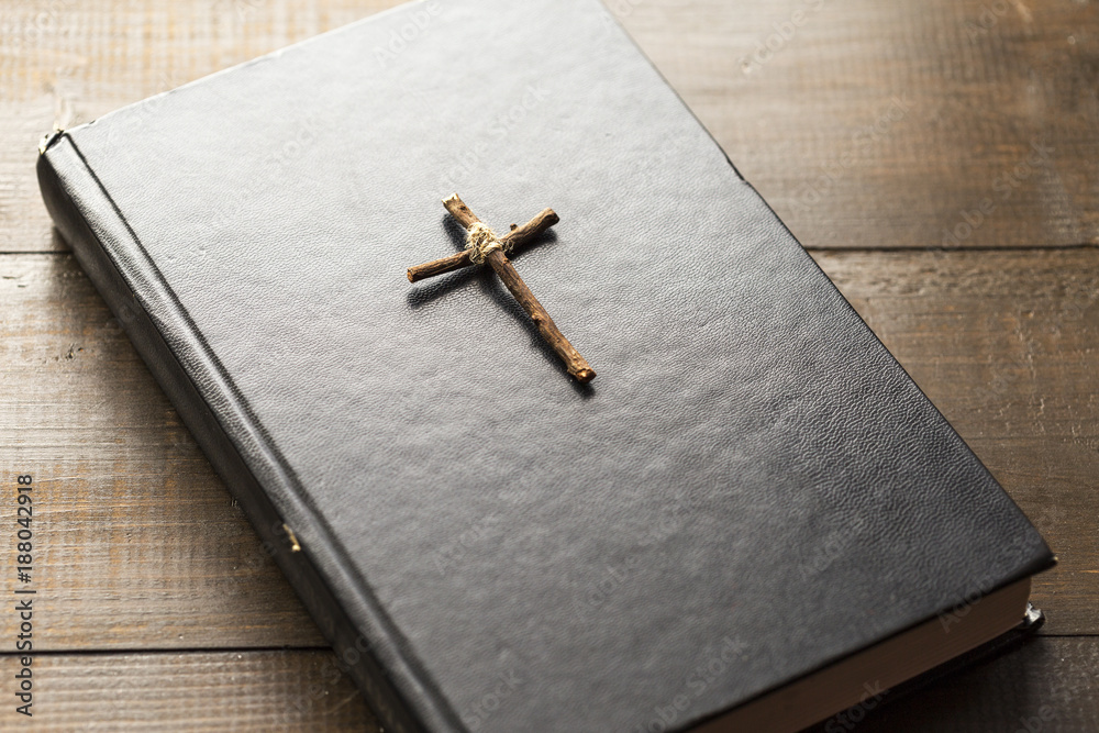Wooden Christian cross on the Bible