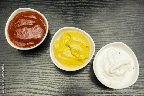 Colorful dips. Garlic sauce, mustard and ketchup.
