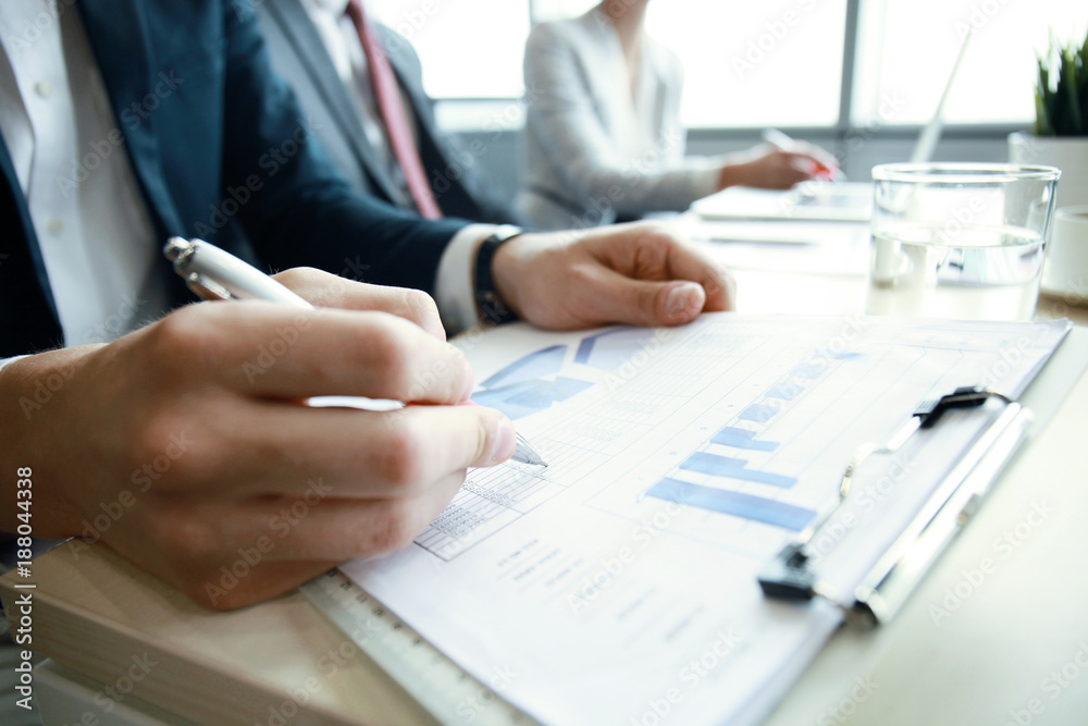Working business people analyse high performance marketing data. Working business people analyse high performance marketing data.