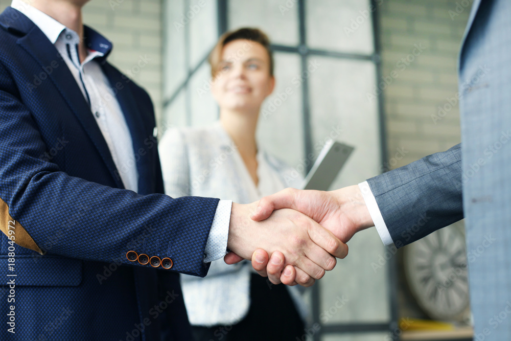 Business people shaking hands, finishing up a meeting.