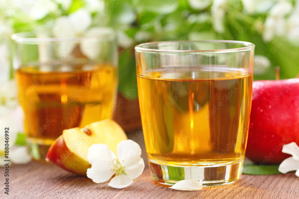 Sweet apple juice, apples and flowers on the table Sweet apple juice, apples and flowers on the table