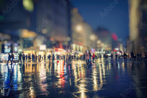 people on the rainy night in the city 