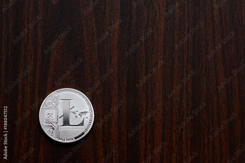 litecoin is lying on a wooden board litecoin is lying on a wooden board
