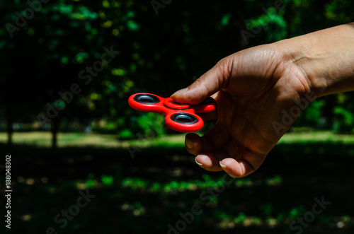 Red fidget spinner in female hand