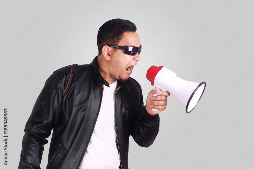 Young Man Shouting with Megaphone, Motivating Concept Young Man Shouting with Megaphone, Motivating Concept