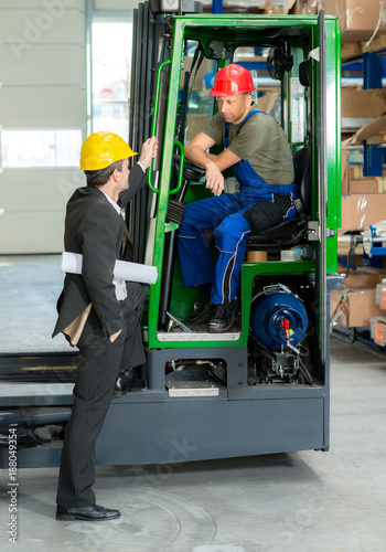 boss and worker in lift truck