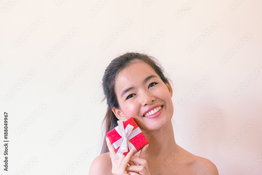 Beauty Skincare concept- Young Asian woman after shower smiling holding velentine’s red box present Beauty Skincare concept- Young Asian woman after shower smiling holding velentine’s red box present