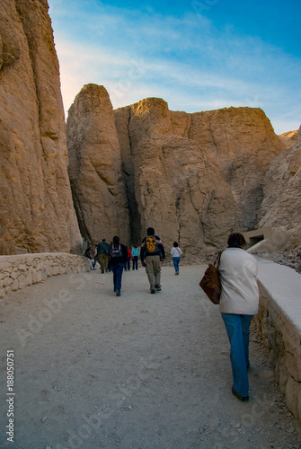 Tourists walking enter the tombs of the Valley of the Kings on the main road and reaching the end