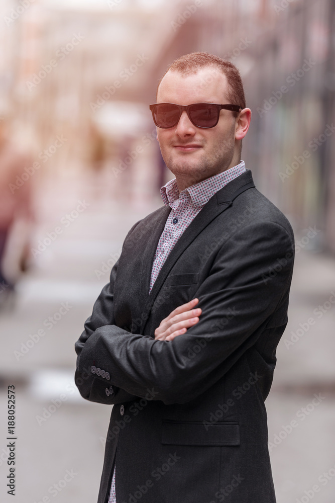 Young entrepreneur businessman looking and smiling, standing confident and proud, outdoors in the streets