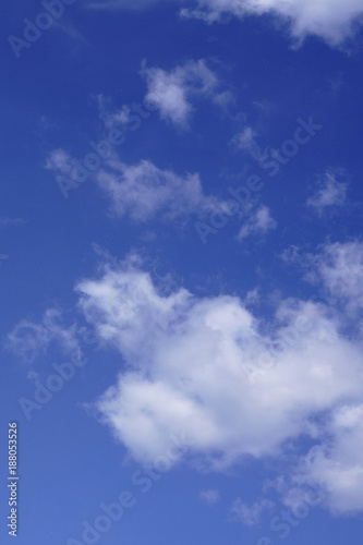 blue sky with many small fluffy cumulus clouds .