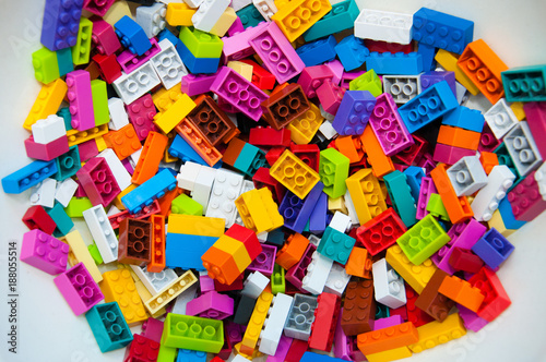 Childrens Designer Background. Multicolored plastic building blocks of the designer.