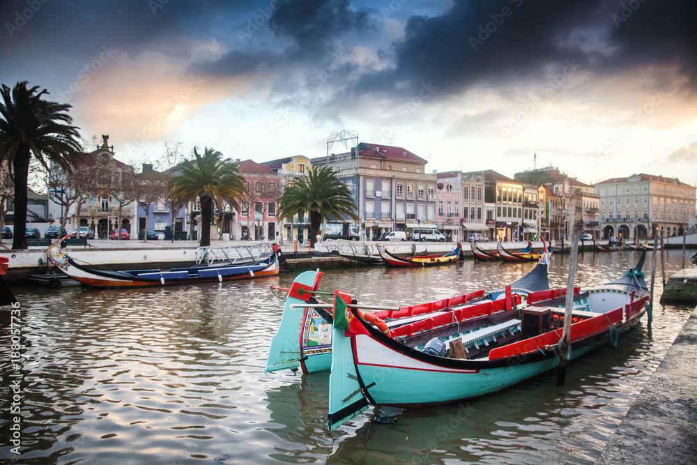 Beautiful cityscape. Bright boats on the pier in Aveiro, Portugal, at sunset
