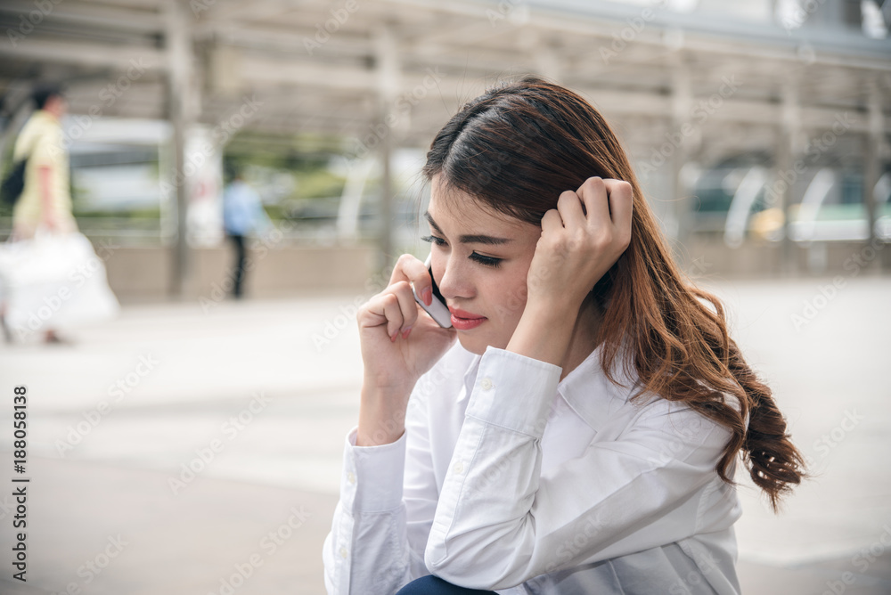 Portraits of beautiful asian woman look confidence is standing and holding cellphone . she using smartphone calling to conversation with customer. Portraits of beautiful asian woman look confidence is standing and holding cellphone . she using smartphone calling to conversation with customer.