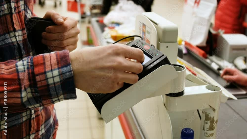 Man uses the card PayPass in the store, 4K. Man uses the card PayPass in the store, 4K.